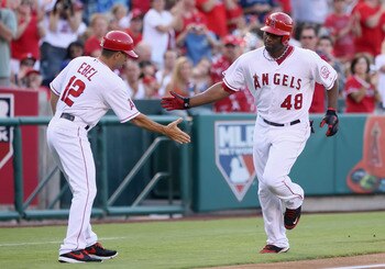 ANAHEIM, CA - JULY 04:  Torii Hunter #48 of the Los Angeles Angels of Anaheim is congratulated by third base coach Dino Ebel #12 after hitting a solo home run against the Detroit Tigers in the first inning at Angel Stadium of Anaheim on July 4, 2011 in An