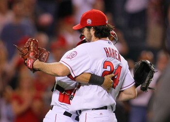 ANAHEIM, CA - JULY 05:  Pitcher Dan Haren #24 of the Los Angeles Angels of Anaheim hugs teammate catcher Jeff Mathis #5 after Haren pitched a 2-hit shutout against the Detroit Tigers in their MLB game at Angel Stadium of Anaheim on July 5, 2011 in Anaheim