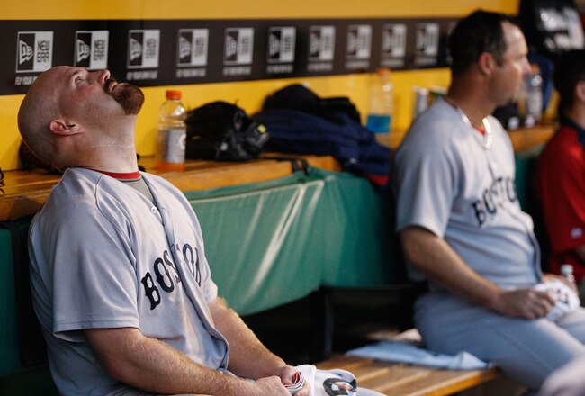 PITTSBURGH - JUNE 25: Kevin Youkilis #20 and teammate Tim Wakefield #49 of the Boston Red Sox sit in the dugout during the game against of the Pittsburgh Pirates on June 25, 2011 at PNC Park in Pittsburgh, Pennsylvania.  (Photo by Jared Wickerham/Getty Im