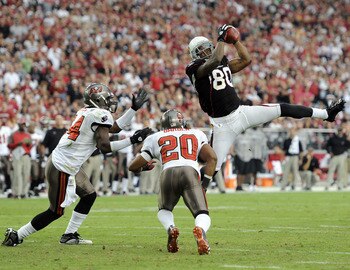 GLENDALE, AZ - OCTOBER 31:  Early Doucet #80 of the Arizona Cardinals makes a catch in front of Ronde Barber #20 and Geno Hayes #54 of the Tampa Bay Buccaneers during the fourth quarter at University of Phoenix Stadium on October 31, 2010 in Glendale, Ari