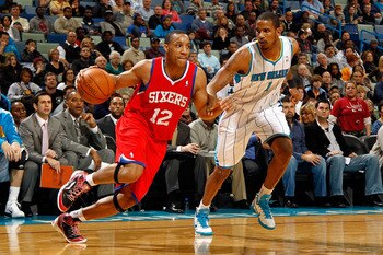 NEW ORLEANS, LA - JANUARY 03:  Evan Turner #12 of the Philadelphia 76ers drives on Trevor Ariza #1 of the New Orleans Hornets in the second half at New Orleans Arena on January 3, 2011 in New Orleans, Louisiana. NOTE TO USER: User expressly acknowledges a