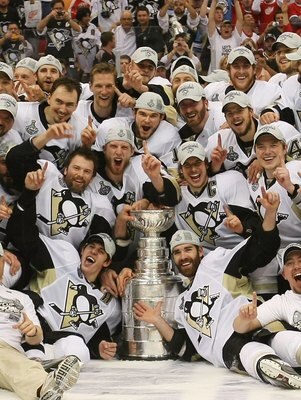 DETROIT - JUNE 12: The Pittsburgh Penguins celebrate with the Stanley Cup following the Penguins victory over the Detroit Red Wings in Game Seven of the 2009 NHL Stanley Cup Finals at Joe Louis Arena on June 12, 2009 in Detroit, Michigan. (Photo by Bruce
