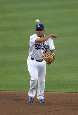 LOS ANGELES, CA - JULY 26:  Shortstop Cesar Izturis #3 of the Los Angeles Dodgers throws the ball to first base against the Cincinnati Reds on July 26, 2005 at Dodger Stadium in Los Angeles, California. The Dodgers won 7-4.  (Photo by Jeff Gross/Getty Ima