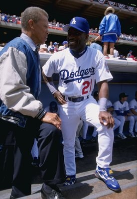 7 Apr 1998:  Infielder Eric Young of the Los Angeles Dodgers stands with former Dodger great Maury Wills in the dugout during a game against the Arizona Diamondbacks at Dodger Stadium in Los Angeles, California. The Dodgers defeated the Diamondbacks 9-1.