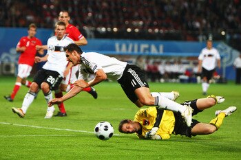 VIENNA, AUSTRIA - JUNE 16: Miroslav Klose of Germany is tackled by goalkeeper Juergen Macho of Austria during the UEFA EURO 2008 Group B match between Austria and Germany at Ernst Happel Stadion on June 16, 2008 in Vienna, Austria.  (Photo by Clive Mason/