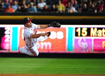 ATLANTA - JULY 6: Dan Uggla #26 of the Atlanta Braves makes a throw against the Colorado Rockies at Turner Field on July 6, 2011 in Atlanta, Georgia. (Photo by Scott Cunningham/Getty Images)