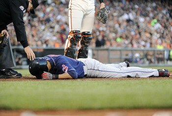 SAN FRANCISCO, CA - JUNE 24: Shin-soo Choo #17 of the Cleveland Indians lies on the ground after being hit in the hand by a pitch from Jonathan Sanchez #57 of the San Francisco Giants in the fourth inning during a MLB baseball game at AT&T Park June 24, 2