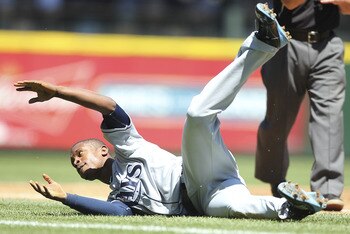 SEATTLE - JUNE 04:  B.J. Upton #2 of the Tampa Bay Rays tumbles over third base trying to advance from first on a single by Sam Fuld #5 against the Seattle Mariners at Safeco Field on June 4, 2011 in Seattle, Washington. (Photo by Otto Greule Jr/Getty Ima