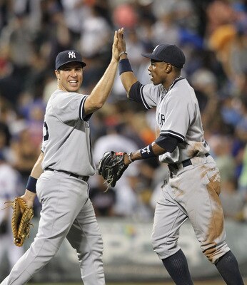 NEW YORK, NY - JULY 01: Mark Teixeira #25 of the New York Yankees celebrates the win with Curtis Granderson #14 against the New York Mets at Citi Field on July 1, 2011 in the Flushing neighborhood of the Queens borough of New York City.  (Photo by Nick La
