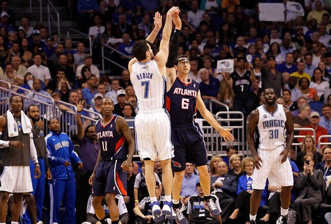 ORLANDO, FL - APRIL 26:  J.J. Redick #7 of the Orlando Magic is fouled by Kirk Hinrich #6 of the Atlanta Hawks during Game Five of the Eastern Conference Quarterfinals of the 2011 NBA Playoffs on April 26, 2011 at the Amway Arena in Orlando, Florida.  NOT