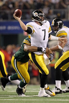 ARLINGTON, TX - FEBRUARY 06:  Ben Roethlisberger #7 of the Pittsburgh Steelers throws the ball as he is hit by a Green Bay Packers defender during Super Bowl XLV at Cowboys Stadium on February 6, 2011 in Arlington, Texas.  (Photo by Ronald Martinez/Getty