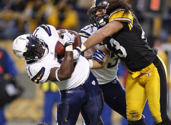 PITTSBURGH - NOVEMBER 16:  LaDanian Tomlinson #21 of the San Diego Chargers scores a first quarter touchdown while taking a hit from Troy Polamalu #43 of the Pittsburgh Steelers during the second quarter on November 16, 2008 at Heinz Field in Pittsburgh,