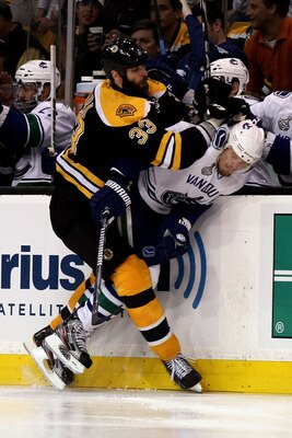 BOSTON, MA - JUNE 13:  Zdeno Chara #33 of the Boston Bruins checks Alexander Edler #23 of the Vancouver Canucks during Game Six of the 2011 NHL Stanley Cup Final at TD Garden on June 13, 2011 in Boston, Massachusetts.  (Photo by Elsa/Getty Images)