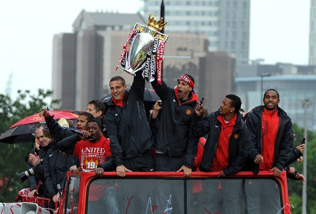 MANCHESTER, ENGLAND - MAY 30: Rio Ferdinand (R) and Nemanja Vidic of Manchester United lift the trophy during the Manchester United Premier League Winners Parade at Old Trafford on May 30, 2011 in Manchester, United Kingdom.  (Photo by Chris Brunskill/Get