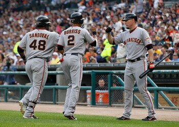DETROIT - JULY 02: Pablo Sandoval #48 of the San Francisco Giants hits a first inning home run and is congratulated by teammates Emmanuel Burriss #2 and Aubrey Huff #17 during the game against the Detroit Tigers at Comerica Park on July 2, 2011 in Detroit