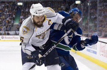 VANCOUVER, CANADA - MAY 7: Shea Weber #6 of the Nashville Predators hits Chris Higgins #20 while battling for the puck in the corner during the third period in Game Five of the Western Conference Semifinals during the 2011 NHL Stanley Cup Playoffs on May