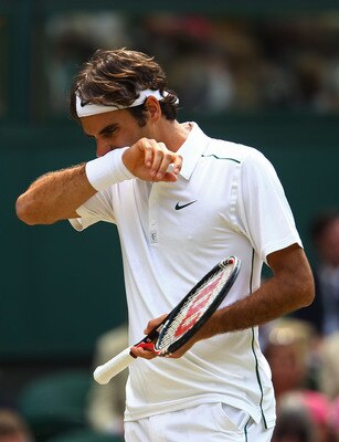 LONDON, ENGLAND - JUNE 29:  Roger Federer of Switzerland looks dejected during his quarterfinal round match against Jo-Wilfried Tsonga of France on Day Nine of the Wimbledon Lawn Tennis Championships at the All England Lawn Tennis and Croquet Club on June
