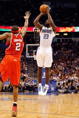 ORLANDO, FL - APRIL 19:  Jason Richardson #23 of the Orlando Magic shoots over Joe Johnson #2 of the Atlanta Hawks of the Orlando Magic during Game Two of the Eastern Conference Quarterfinals of the 2011 NBA Playoffs on April 19, 2011 at the Amway Arena i