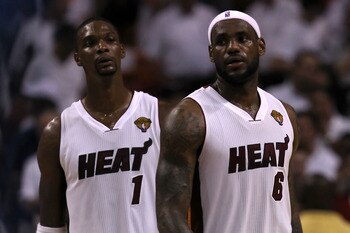 MIAMI, FL - JUNE 12:  (L-R) Chris Bosh #1 and LeBron James #6 of the Miami Heat look on against the Dallas Mavericks in Game Six of the 2011 NBA Finals at American Airlines Arena on June 12, 2011 in Miami, Florida. NOTE TO USER: User expressly acknowledge