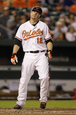 BALTIMORE, MD - MAY 12: Mark Reynolds #12 of the Baltimore Orioles after striking out against the Seattle Mariners at Oriole Park at Camden Yards on May 12, 2011 in Baltimore, Maryland.  (Photo by Rob Carr/Getty Images)
