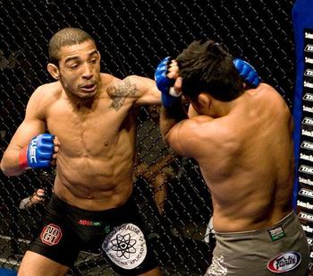 Jose Aldo unloading a barrage of punches