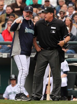 SEATTLE - JUNE 29:  Manager Eric Wedge #22 of the Seattle Mariners argues with home plate umpire Paul Emmel #50 after being ejected from the game against the Atlanta Braves at Safeco Field on June 29, 2011 in Seattle, Washington. (Photo by Otto Greule Jr/