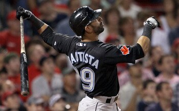 BOSTON, MA - JULY 05:  Jose Bautista #19 of the Toronto Blue Jays hits a two run homer in the ninth inning against the Boston Red Sox on July 5, 2011 at Fenway Park in Boston, Massachusetts.  (Photo by Elsa/Getty Images)