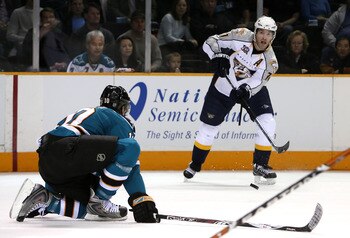 SAN JOSE, CA - FEBRUARY 09:  J.P. Dumont #71 of the Nashville Predators centers the puck past Christian Ehrhoff #10 of the San Jose Sharks during the second period of the NHL game at HP Pavilion on February 9, 2008 in San Jose, California.  (Photo by Chri