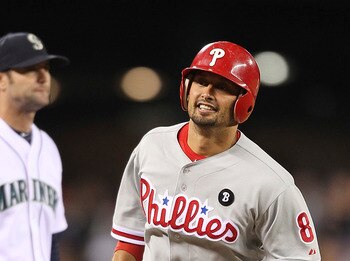 SEATTLE - JUNE 18:  Shane Victorino #8 of the Philadelphia Phillies rounds the bases past third baseman Adam Kennedy #4 after hitting a two-run homer in the ninth inning against the Seattle Mariners at Safeco Field on June 18, 2011 in Seattle, Washington.