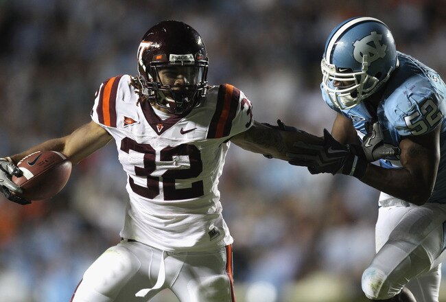 CHAPEL HILL, NC - NOVEMBER 13:  Darren Evans #32 of the Virginia Tech Hokies is tackled by Quan Sturdivant #52 of the North Carolina Tar Heels during their game at Kenan Stadium on November 13, 2010 in Chapel Hill, North Carolina.  (Photo by Streeter Leck
