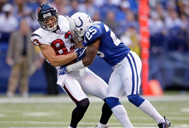 INDIANAPOLIS - NOVEMBER 8:  Kevin Walter #83 of the  Houston Texans runs with the ball while tackled by Jerraud Powers #25 of the Indianapolis Colts during the NFL game at Lucas Oil Stadium on November 8, 2009 in Indianapolis, Indiana.  The Colts defeated