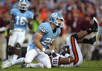 CHAPEL HILL, NC - NOVEMBER 13:  Jarrett Boykin #81 of the Virginia Tech Hokies makes a catch as Matt Merletti #25 of the North Carolina Tar Heels reacts to the play during their game at Kenan Stadium on November 13, 2010 in Chapel Hill, North Carolina.  (