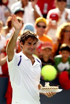 MONTREAL - AUGUST 08: Roger Federer of Switzerland acknowledges the crowd after receiving a cake for his 26th birthday following his victory orver ivo Karlovic of Croatia during the Coupe Rogers August 8, 2007 at Stade Uniprix in Montreal, Quebec, Canada.