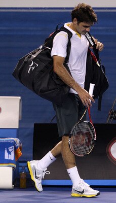 MELBOURNE, AUSTRALIA - JANUARY 27:  Roger Federer of Switzerland walks off court after losing his semifinal match against Novak Djokovic of Serbia during day eleven of the 2011 Australian Open at Melbourne Park on January 27, 2011 in Melbourne, Australia.