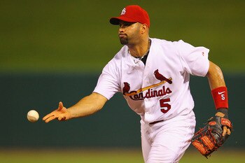ST. LOUIS, MO - JULY 9: Albert Pujols #5 of the St. Louis Cardinals flips the ball to first base against the Arizona Diamondbacks at Busch Stadium on July 9, 2011 in St. Louis, Missouri.  The Cardinals beat the Diamondbacks 7-6.  (Photo by Dilip Vishwanat