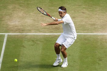 LONDON, ENGLAND - JUNE 29:  Roger Federer of Switzerland returns a shot during his quarterfinal round match against Jo-Wilfried Tsonga of France on Day Nine of the Wimbledon Lawn Tennis Championships at the All England Lawn Tennis and Croquet Club on June