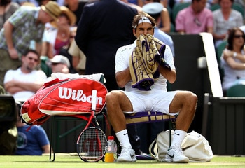 LONDON, ENGLAND - JUNE 29:  Roger Federer of Switzerland takes a break during his quarterfinal round match against Jo-Wilfried Tsonga of France on Day Nine of the Wimbledon Lawn Tennis Championships at the All England Lawn Tennis and Croquet Club on June