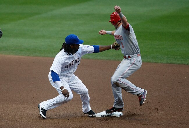 MILWAUKEE, WI - JULY 8: Drew Stubbs #6 of the Cincinnati Reds jumps in an attempt to avoid a tag by Rickie Weeks #23 of the Milwaukee Brewers at Miller Park on July 8, 2011 in Milwaukee, Wisconsin. (Photo by Scott Boehm/Getty Images)