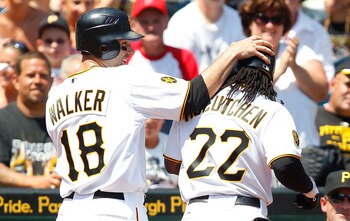 PITTSBURGH, PA - JULY 10:  Neil Walker #18 of the Pittsburgh Pirates congratulates teammates Andrew McCutchen #22 after Walker scored on a sacrifice fly from McCutchen against the Chicago Cubs during the game on July 10, 2011 at PNC Park in Pittsburgh, Pe