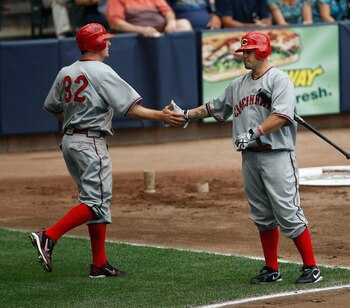 MILWAUKEE, WI - JULY 9:  Jay Bruce #32 of the Cincinnati Reds is congratulated by Ramon Hernandez #55 after scoring a run against the Milwaukee Brewers at Miller Park on July 9, 2011 in Milwaukee, Wisconsin. (Photo by Scott Boehm/Getty Images)