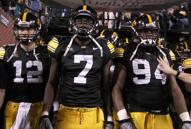 TEMPE, AZ - DECEMBER 28:  (L-R) Ricky Stanzi #12, Marvin McNutt #7 and Adrian Clayborn #94 of the Iowa Hawkeyes walk out onto the field for the Insight Bowl against the Missouri Tigers at Sun Devil Stadium on December 28, 2010 in Tempe, Arizona. The Hawke