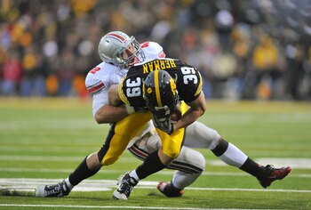 IOWA CITY, IA - NOVEMBER 20:  Linebacker Andrew Sweat #42 of the Ohio State Buckeyes tackles tight end Brad Herman #39 of the University of Iowa Hawkeyes during the second half of play at Kinnick Stadium on November 20, 2010 in Iowa City, Iowa. Ohio State