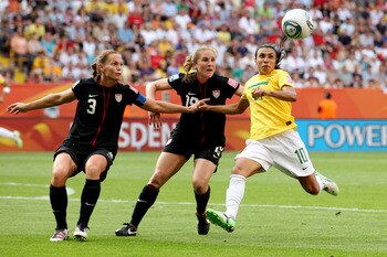 DRESDEN, GERMANY - JULY 10:  Marta of Brazil (R) in action with Christie Rampone (L) and Rachel Buehler of USA during the Women's World Cup Quarter Final match between Brazil and USA at Rudolf-Harbig Stadium on July 10, 2011 in Dresden, Germany.  (Photo b