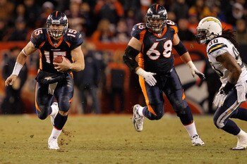 DENVER, CO - JANUARY 2:  Quarterback Tim Tebow #15 of the Denver Broncos runs for a first down past linebacker Antwan Applewhite #90 of the San Diego Chargers as guard Zane Beadles #68 trails the play during the fourth quarter at INVESCO Field at Mile Hig