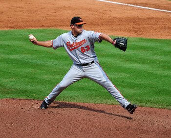 ATLANTA - JULY 3: Kevin Gregg #63 of the Baltimore Orioles pitches against the Atlanta Braves at Turner Field on July 3, 2011 in Atlanta, Georgia. (Photo by Scott Cunningham/Getty Images)