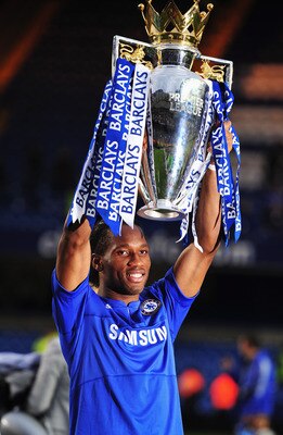 LONDON, ENGLAND - MAY 09:  Didier Drogba of Chelsea celebrates with the trophy as they win the title after the Barclays Premier League match between Chelsea and Wigan Athletic at Stamford Bridge on May 9, 2010 in London, England. Chelsea won 8-0 to win th