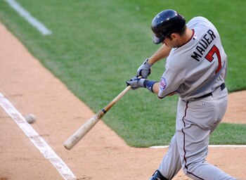 CHICAGO, IL - JULY 07:  Joe Mauer #7 of the Minnesota Twins hits an RBI single in the first inning against the Chicago White Sox on July 7, 2011 at U.S. Cellular Field in Chicago, Illinois.  (Photo by David Banks/Getty Images)