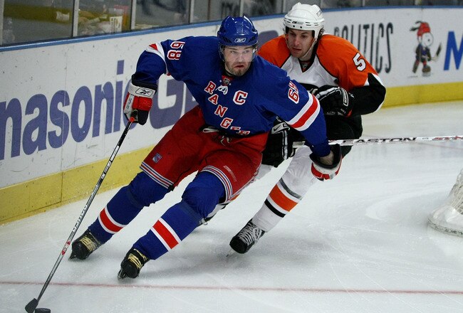 NEW YORK - MARCH 25: Jaromir Jagr #68 of the New York Rangers keeps the puck from Braydon Coburn #5 of the Philadelphia Flyers during their game on March 25, 2008 at Madison Square Garden in New York City.  (Photo by Chris McGrath/Getty Images)