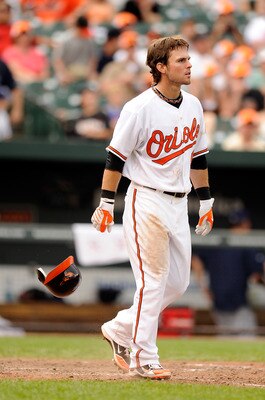 BALTIMORE, MD - JUNE 12:  Ryan Adams #6 of the Baltimore Orioles tosses his helmet after striking out against the Tampa Bay Rays at Oriole Park at Camden Yards on June 12, 2011 in Baltimore, Maryland.  (Photo by Greg Fiume/Getty Images)