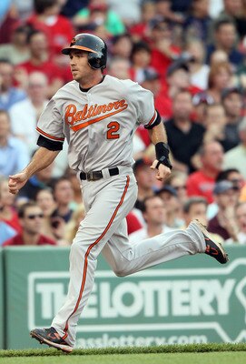 BOSTON, MA - JULY 07:  J.J. Hardy #2 of the Baltimore Orioles scores a run in the first inning against the Boston Red Sox on July 7, 2011 at Fenway Park in Boston, Massachusetts.  (Photo by Elsa/Getty Images)